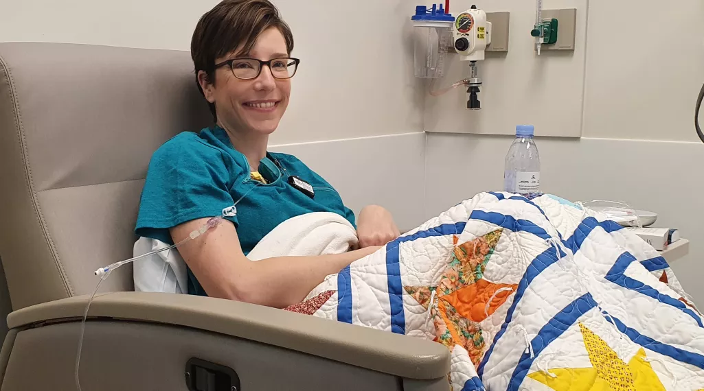 A photograph of Lexie in a chemotherapy chair.