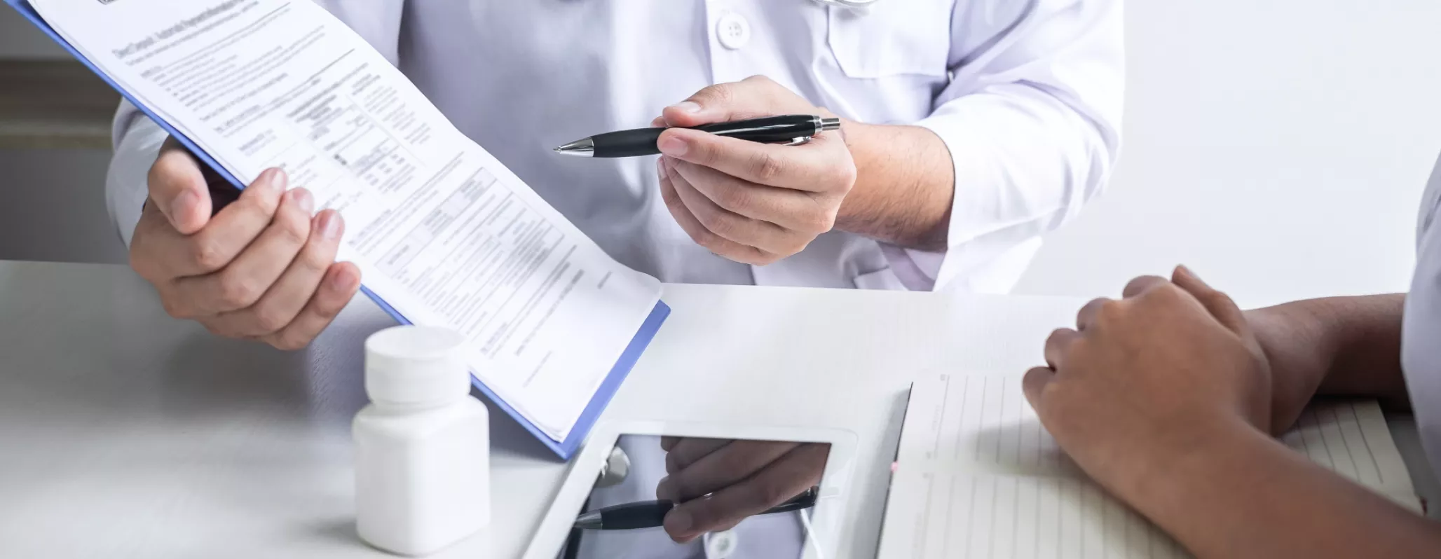 A doctor explains a form to a patient