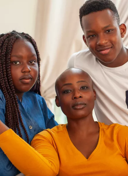 Woman with two kids looking at camera