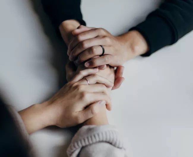 two people holding hands on table