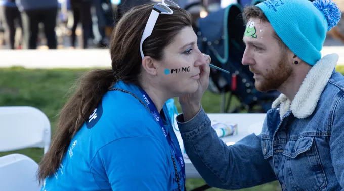 Man paints woman's face