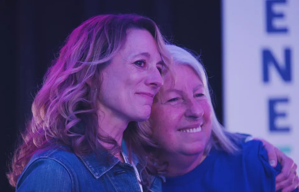 Two women hugging at AllyCon 2024