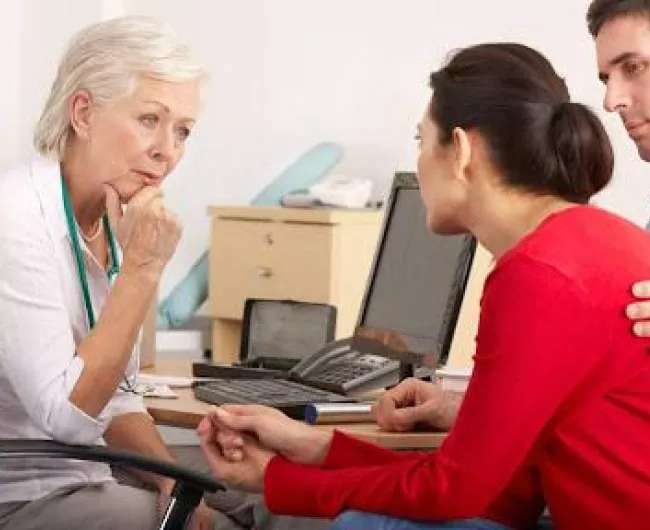 doctor speaking to couple