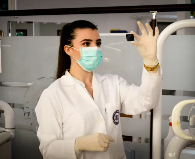 female scientist inspects a specimen
