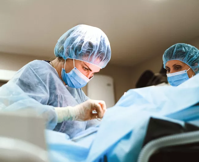 female surgeon with assistant