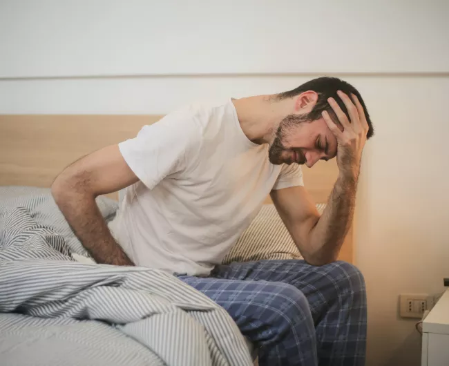 man in bed upset