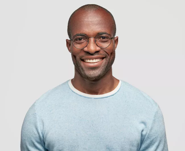 man smiling in blue sweater