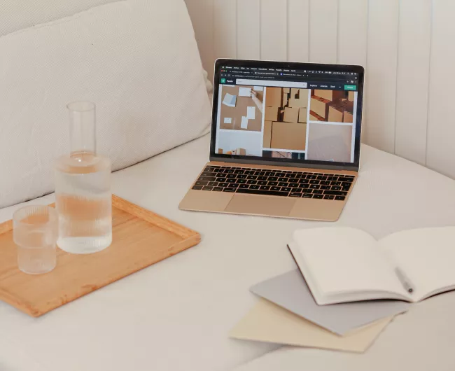 bed with laptop and water bottle