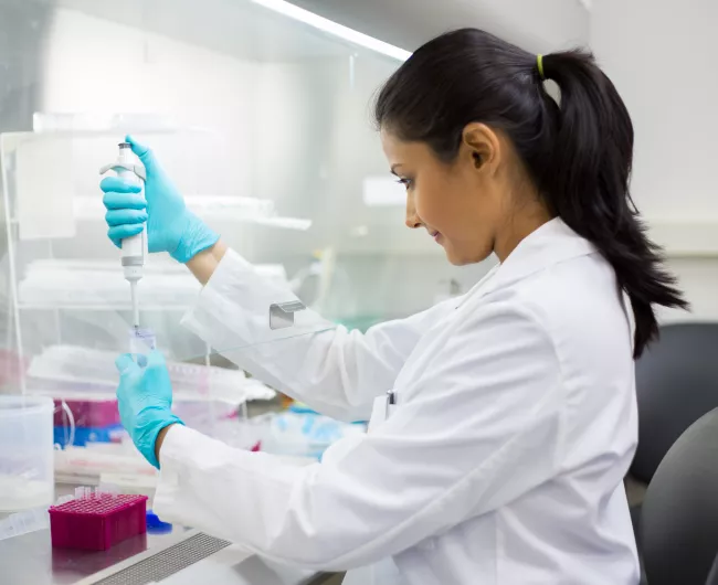 woman in lab in white coat