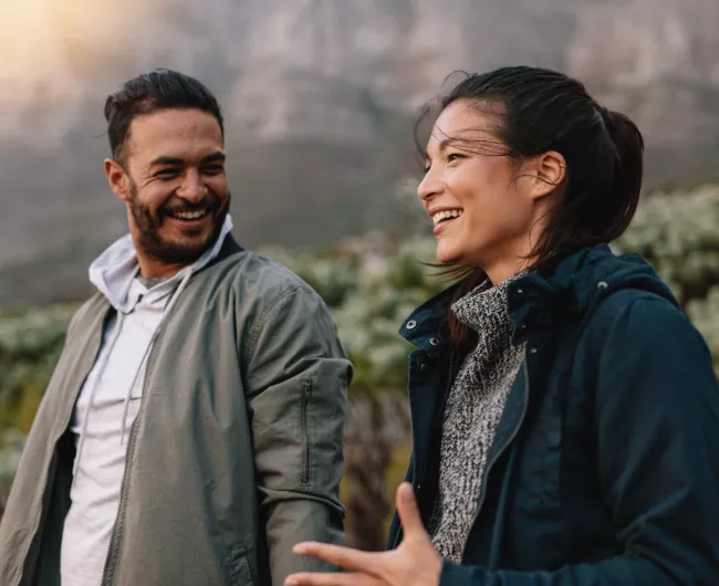 younger couple waking in park