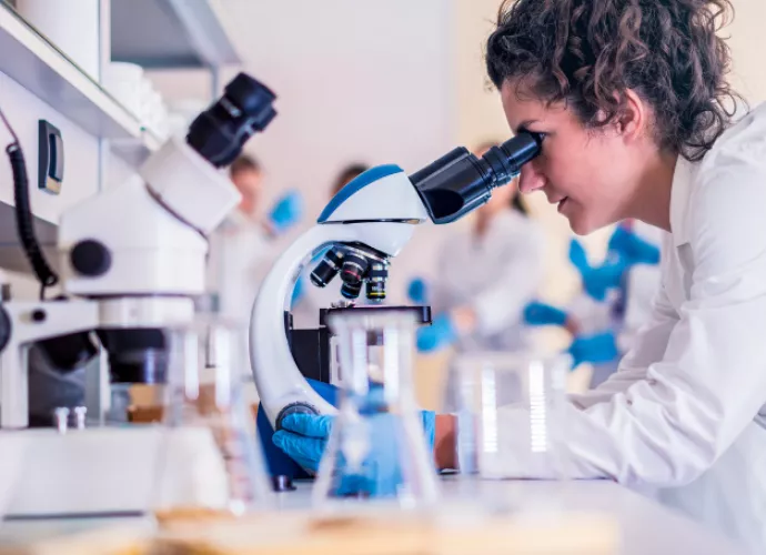 Researcher studying through microscope