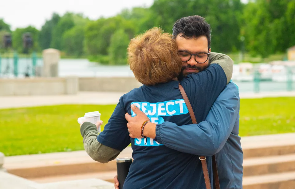 man and woman hugging